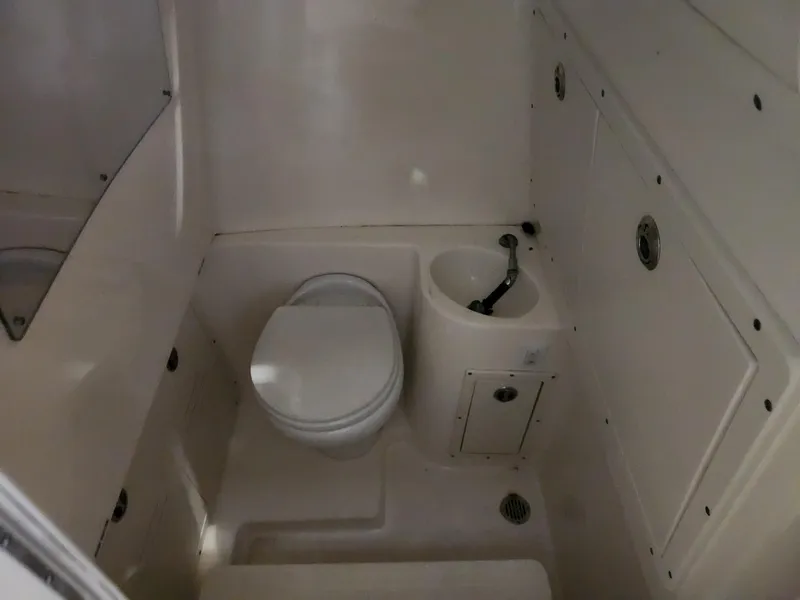Slide: The Image of 2016 Key West 281 Billistic boat bathroom with toilet and sink. - 22