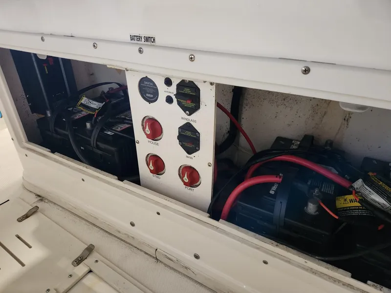 Slide: The Image of Battery compartment of 2016 Key West 281 Billistic boat with switches and wiring. - 23