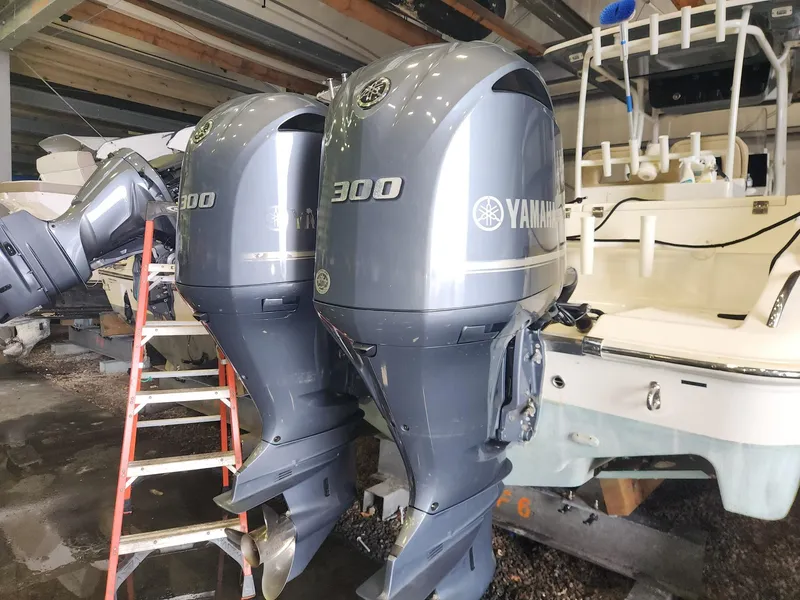 Slide: The Image of 2016 Key West 281 Billistic boat with dual Yamaha 300 outboard engines in a storage area. - 27