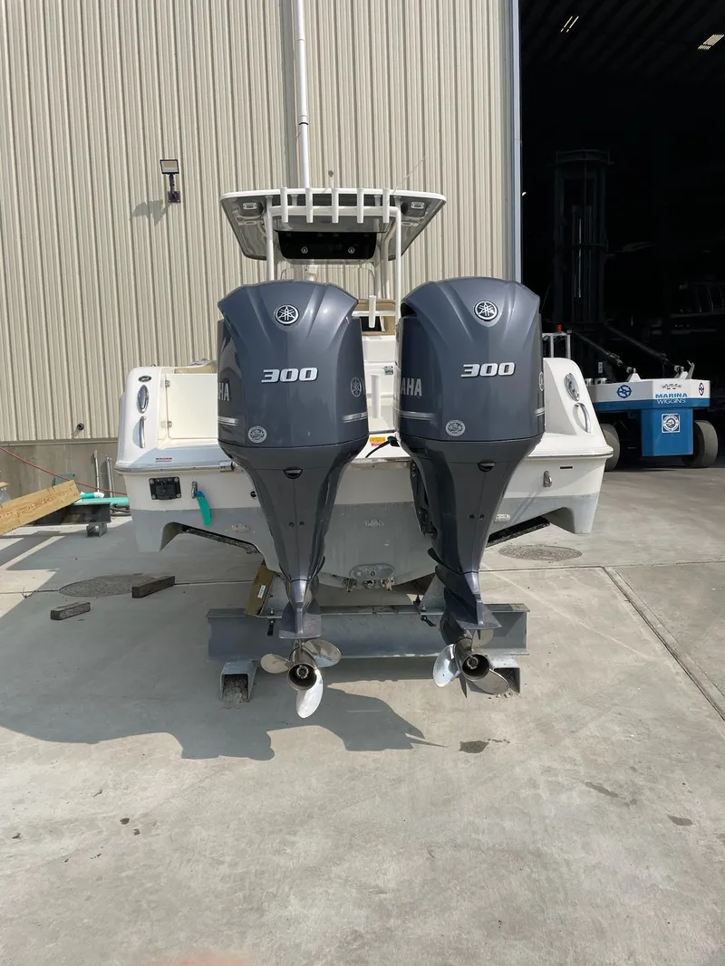 Slide: The Image of 2016 Key West 281 Billistic boat with twin Yamaha 300 engines, parked outdoors. - 33