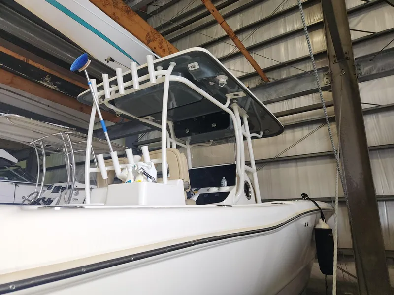 Slide: The Image of 2016 Key West 281 Billistic boat in storage, featuring a sleek design and sturdy T-top. - 6