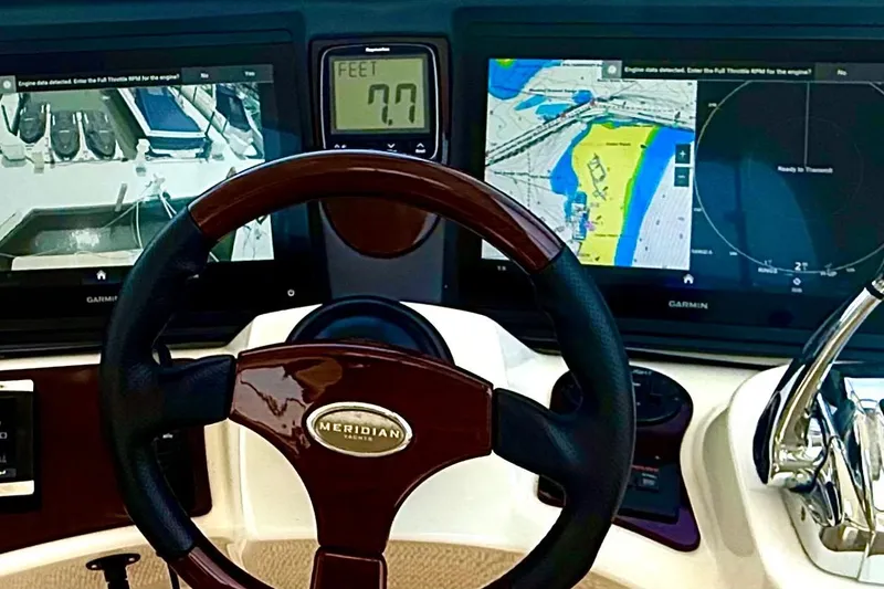 Slide: The Image of Steering wheel and navigation screens of a 2014 Meridian 441 Sedan yacht. - 19