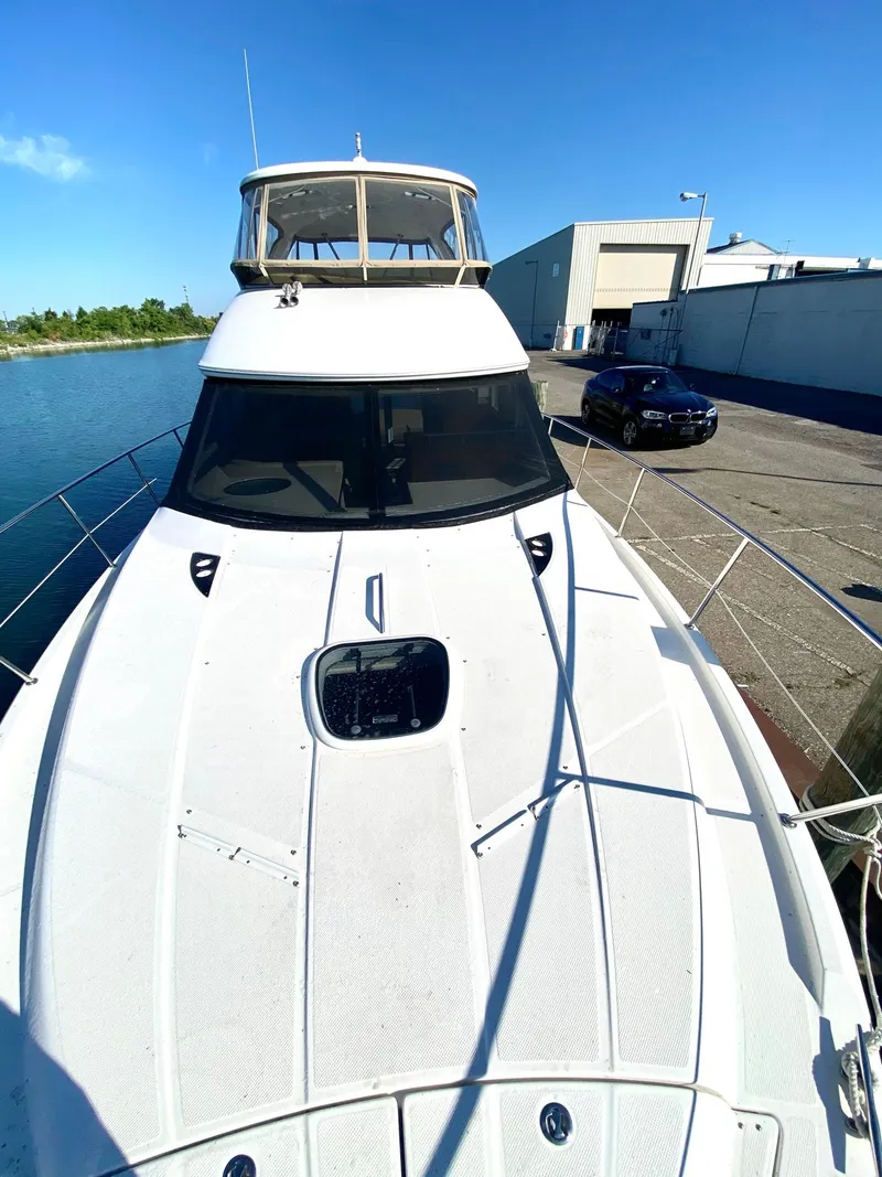 Slide: The Image of 2014 Meridian 441 Sedan yacht docked at marina under clear blue sky. - 6