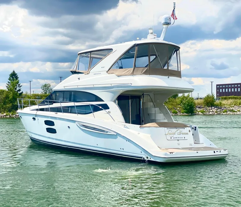 Slide: The Image of 2014 Meridian 441 Sedan yacht on calm water under cloudy sky. - 3