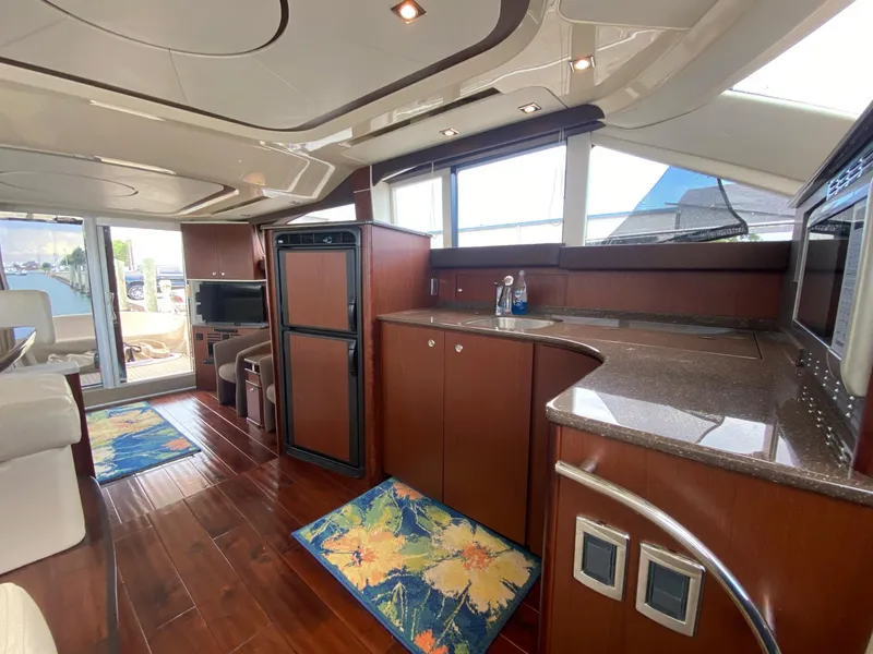 Slide: The Image of Luxurious interior of 2014 Meridian 441 Sedan yacht with modern kitchen and seating area. - 12