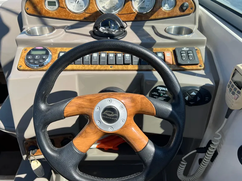 Slide: The Image of 2008 Rinker 260 Express Cruiser dashboard with steering wheel and control panel. - 10
