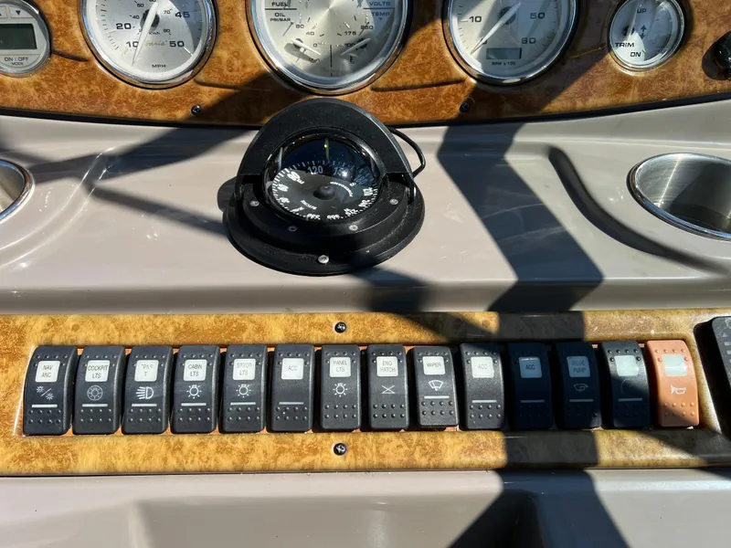 Slide: The Image of Dashboard of a 2008 Rinker 260 Express Cruiser with gauges and switches. - 11