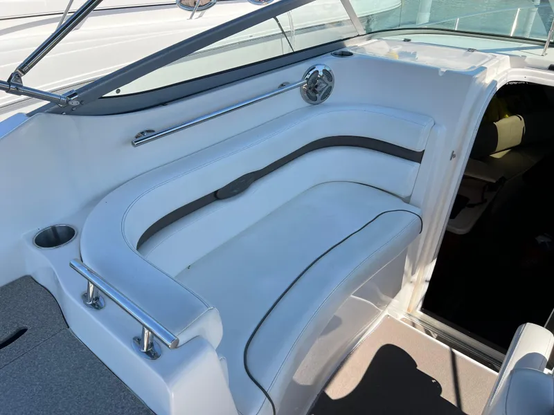 Slide: The Image of 2008 Rinker 260 Express Cruiser interior seating with white upholstery and stainless steel accents. - 13