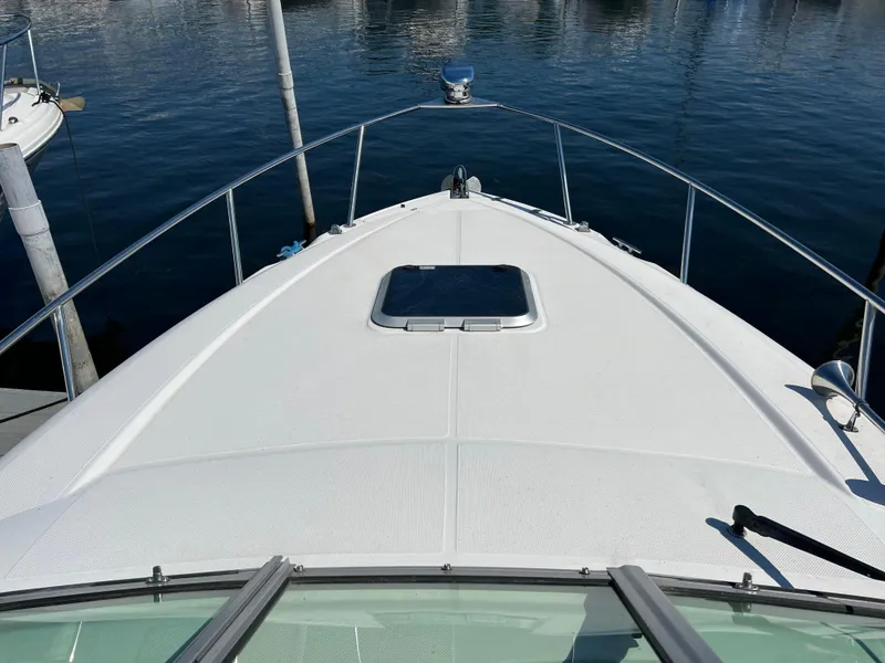 Slide: The Image of 2008 Rinker 260 Express Cruiser bow view on calm water. - 14