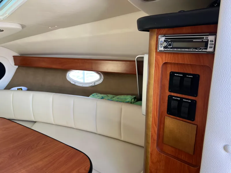 Slide: The Image of Interior of 2008 Rinker 260 Express Cruiser with wood accents and seating. - 23