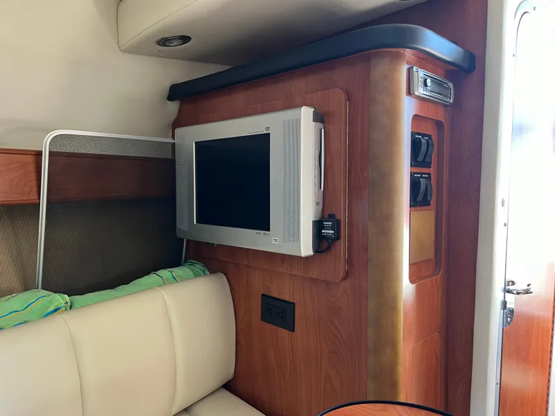 Slide: The Image of Interior of 2008 Rinker 260 Express Cruiser with TV and seating area. - 24