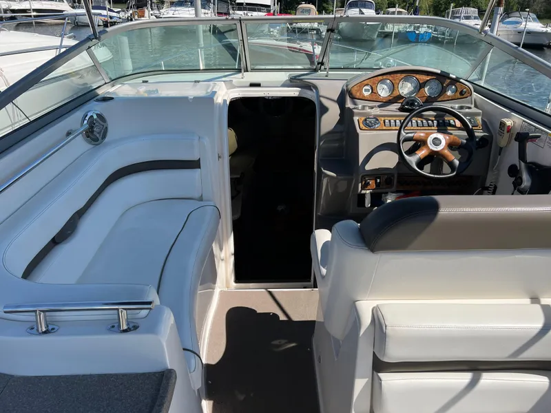 Slide: The Image of 2008 Rinker 260 Express Cruiser interior with steering wheel and seating area. - 7