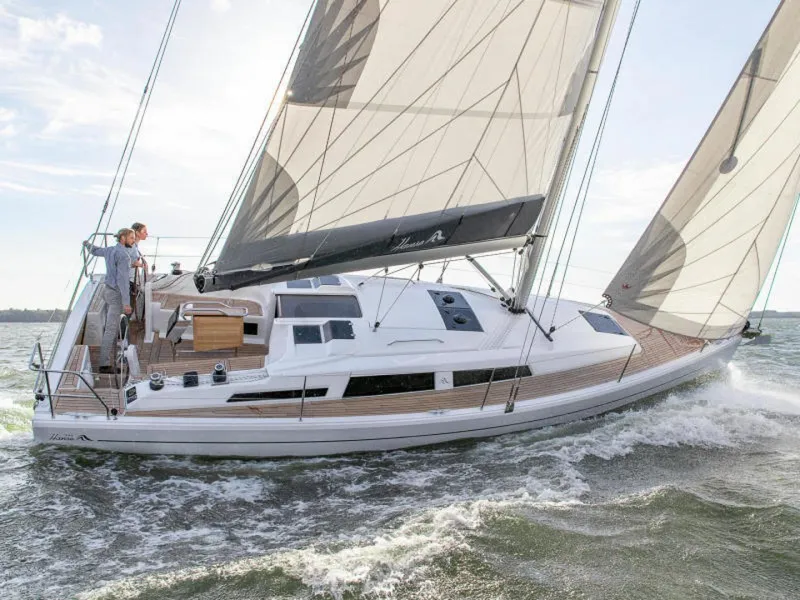 Slide: The Image of 2025 Hanse 348 yacht sailing on open water, sleek design, white hull, spacious deck. - 3