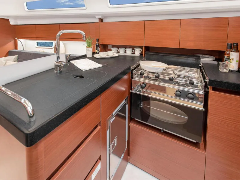 Slide: The Image of Modern kitchen in 2025 Hanse 348 yacht with sleek wood cabinetry and stainless steel appliances. - 8