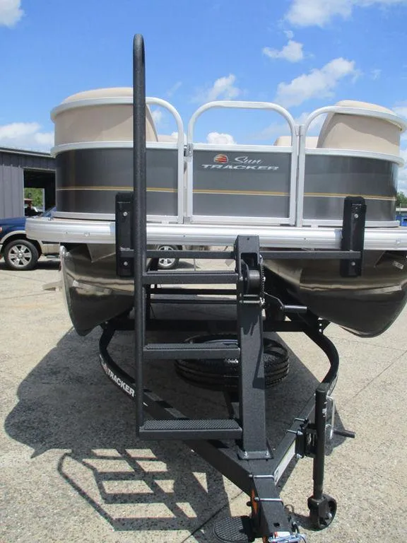 Slide: The Image of 2024 Sun Tracker PARTY BARGE® 18 DLX pontoon boat on trailer, sunny day. - 12