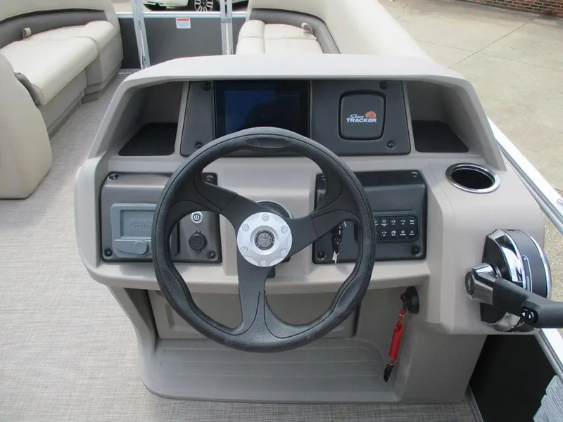Slide: The Image of 2024 Sun Tracker PARTY BARGE® 18 DLX steering console with modern controls and seating. - 5