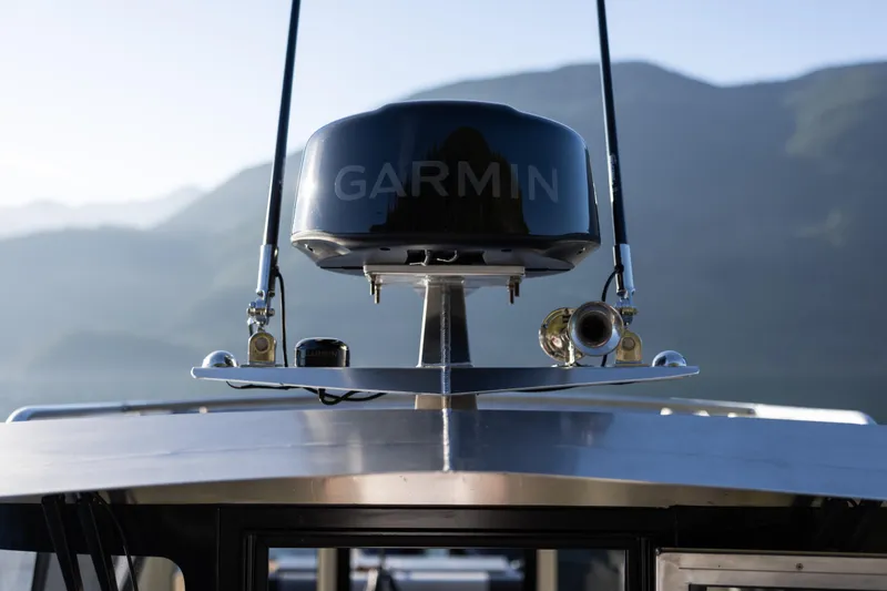Slide: The Image of 2026 Jasper Marine Defender 22 boat with Garmin radar, mountain backdrop. - 21