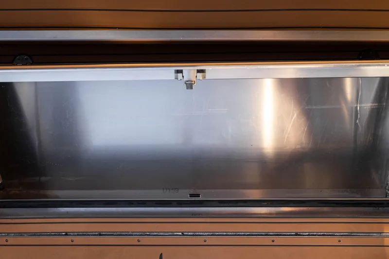 Slide: The Image of Open storage compartment on Jasper Marine Defender 22 boat, 2026 model. - 25