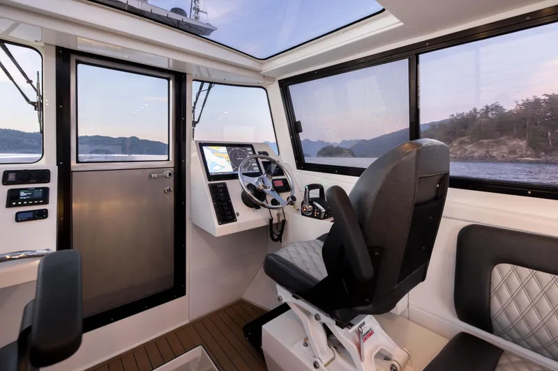 Slide: The Image of Interior of 2026 Jasper Marine Defender 22 boat, featuring modern navigation controls and seating. - 29