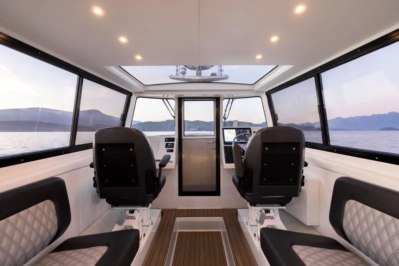 Slide: The Image of Interior of 2026 Jasper Marine Defender 22 boat with modern seating and panoramic windows. - 36