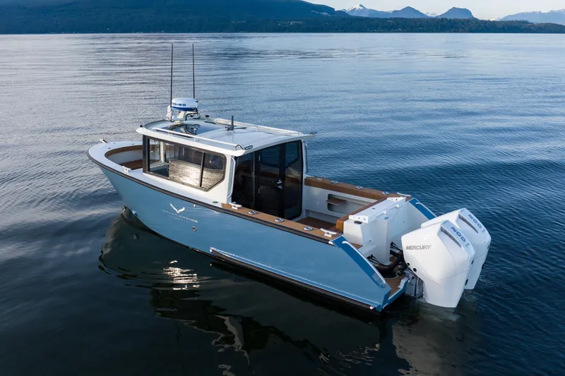 Slide: The Image of 2026 Jasper Marine Defender 22 boat on calm water with twin Mercury engines. - 45