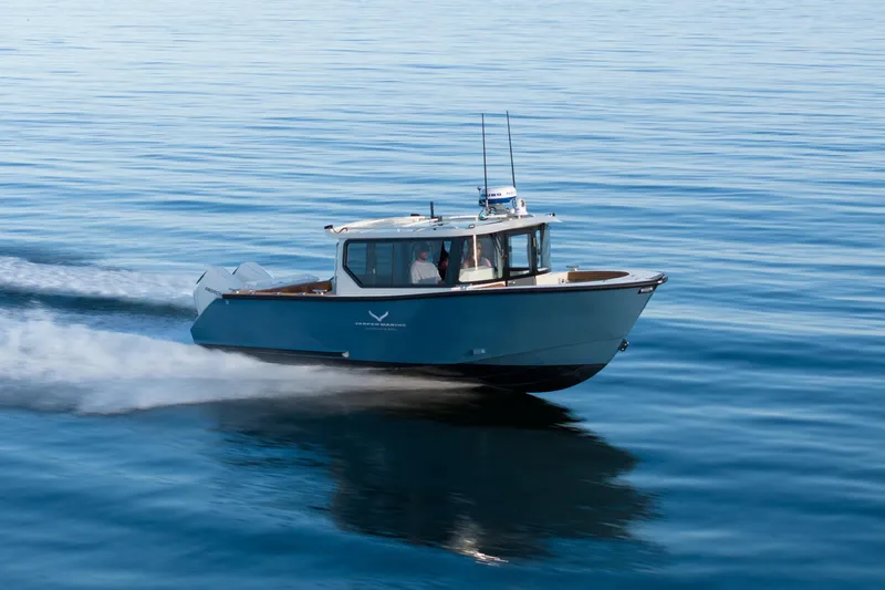 Slide: The Image of 2026 Jasper Marine Defender 22 cruising on calm blue waters. - 47