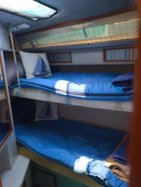 Slide: The Image of Interior cabin of 1989 Sea Ray 390 Express Cruiser with bunk beds and nautical decor. - 19