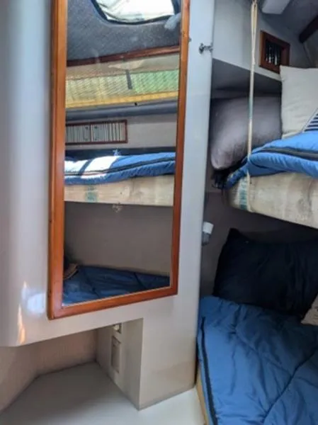 Slide: The Image of 1989 Sea Ray 390 Express Cruiser cabin with bunk beds and mirror. - 20