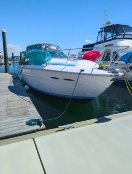 Slide: The Image of 1989 Sea Ray 390 Express Cruiser docked at marina under clear blue sky. - 3