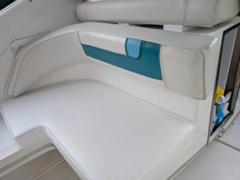 Slide: The Image of 1989 Sea Ray 390 Express Cruiser interior seating with white and teal upholstery. - 8