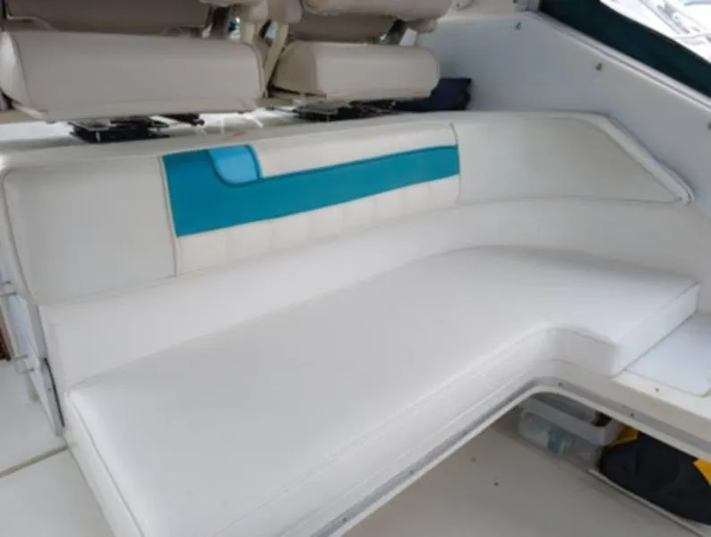 Slide: The Image of 1989 Sea Ray 390 Express Cruiser interior seating with white and blue upholstery. - 9