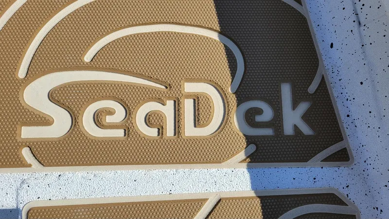Slide: The Image of SeaDek logo on textured surface, featured on 2025 Xpress H22 Bay boat. - 14