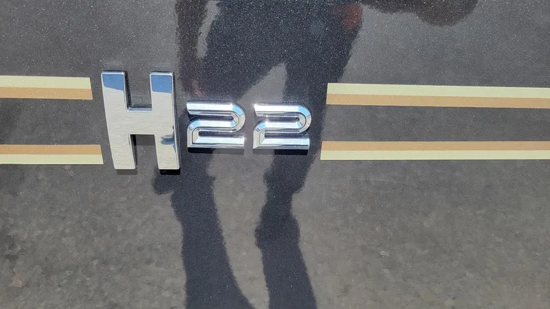 Slide: The Image of 2025 Xpress H22 Bay boat emblem with reflective chrome finish. - 9