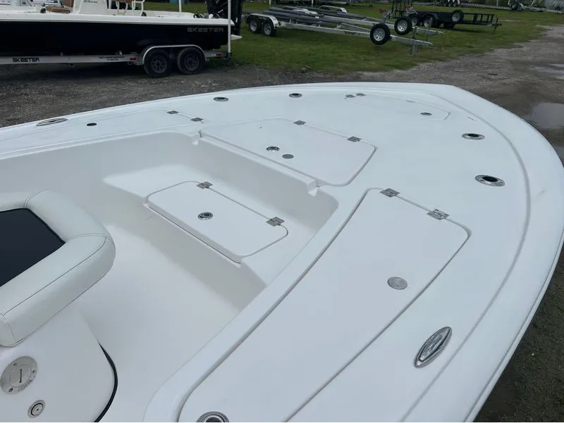 Slide: The Image of 2025 Tidewater 2110 Baymax boat deck with storage compartments and seating. - 8