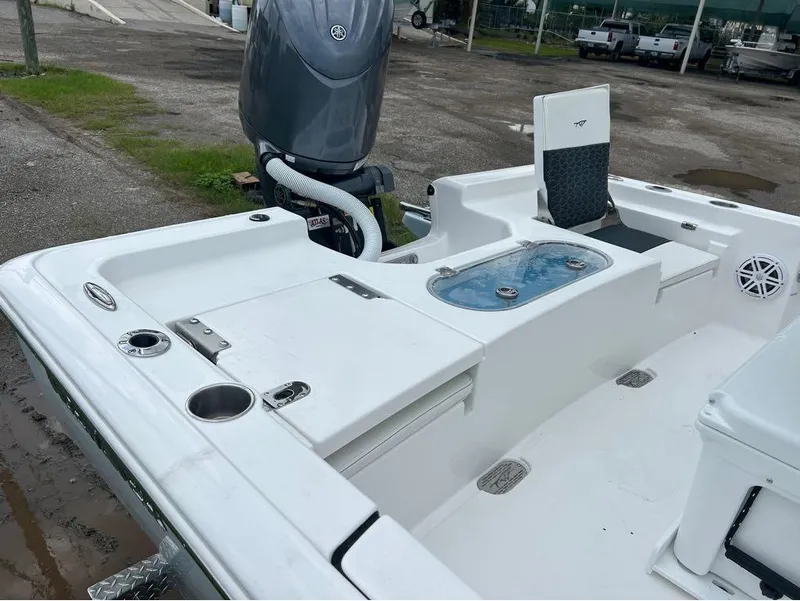 Slide: The Image of 2025 Tidewater 2110 Baymax boat interior with seating and motor, parked on a lot. - 9