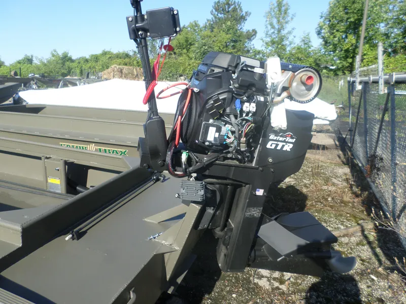 Slide: The Image of 2024 Gator Trax 16' Marsh Series boat with GTR motor in outdoor setting. - 2