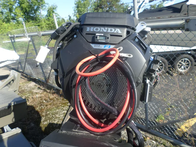 Slide: The Image of 2024 Gator Trax 16' Marsh Series with Honda engine, outdoor setting. - 3