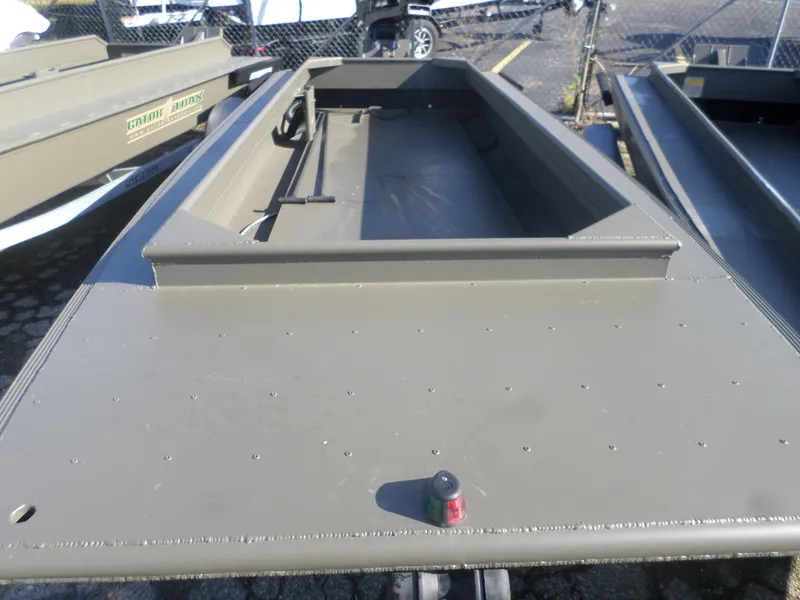 Slide: The Image of 2024 Gator Trax 16' Marsh Series boat, olive green, parked outdoors. - 4