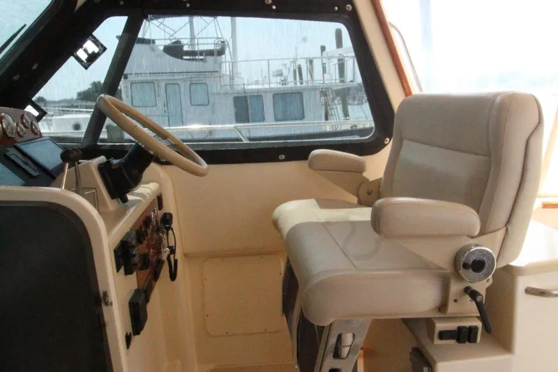 Slide: The Image of Interior of a 2002 Island Packet 360 yacht with steering wheel and seat. - 15