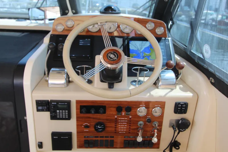 Slide: The Image of Island Packet 360 yacht helm, 2002 model, featuring wood paneling and navigation system. - 16