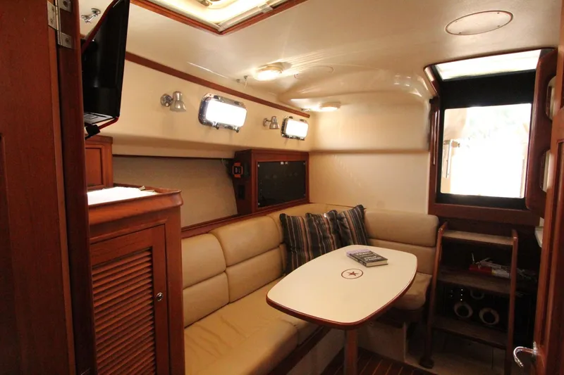 Slide: The Image of Interior of a 2002 Island Packet 360 yacht with cozy seating area. - 24