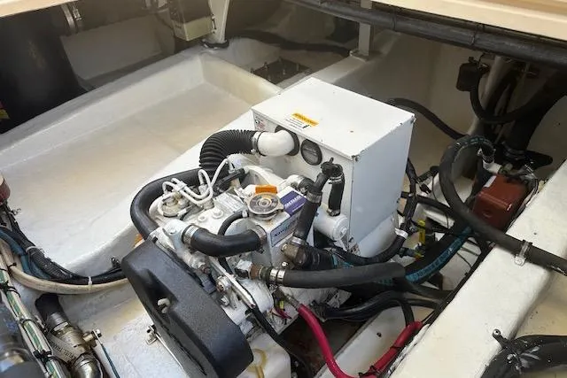 Slide: The Image of Engine compartment of a 2002 Island Packet Packet Craft 36, showcasing mechanical components and wiring. - 33
