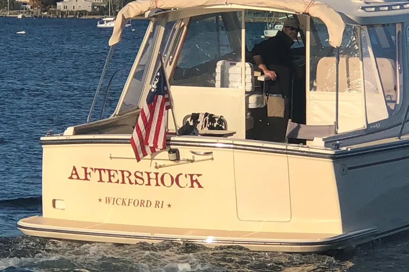 Slide: The Image of 2002 Island Packet 360 boat with US flag on the water. - 34