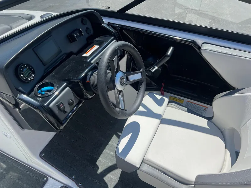Slide: The Image of 2023 Yamaha AR 190 jet boat cockpit with steering wheel and dashboard controls. - 12
