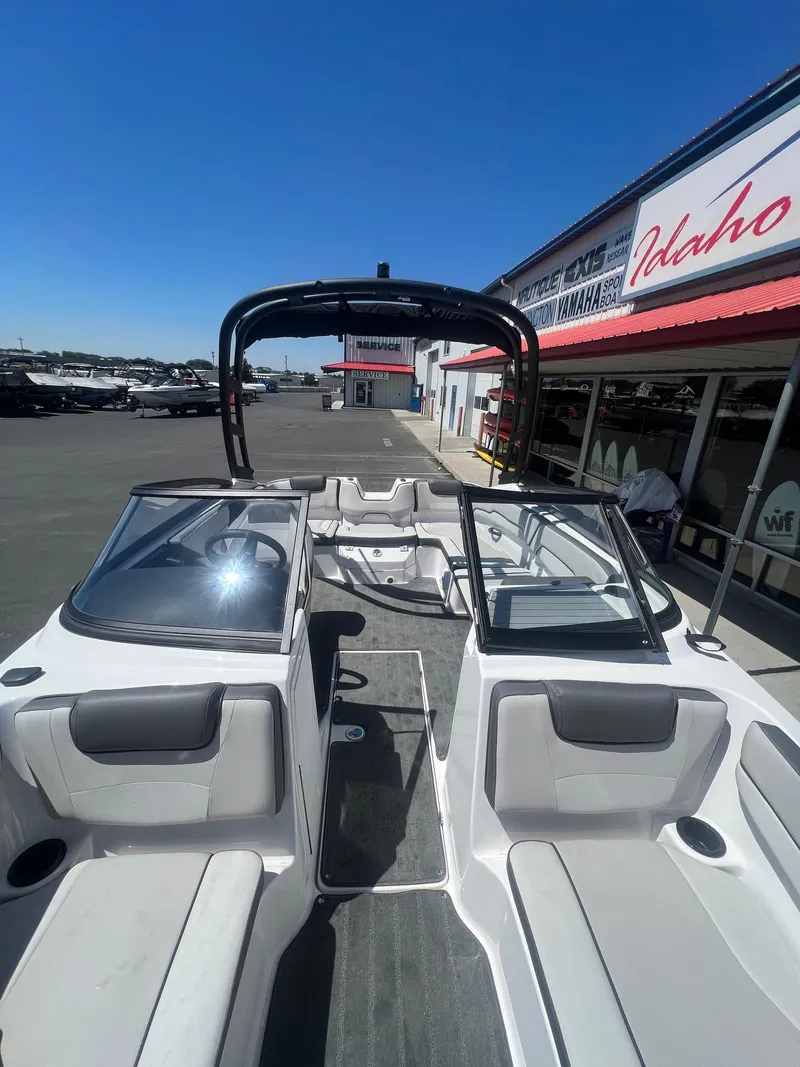 Slide: The Image of 2023 Yamaha AR 190 jet boat interior at dealership, showcasing seating and dashboard. - 14