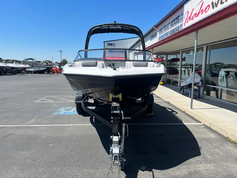 Slide: The Image of 2023 Yamaha AR 190 jet boat on trailer at dealership parking lot. - 5