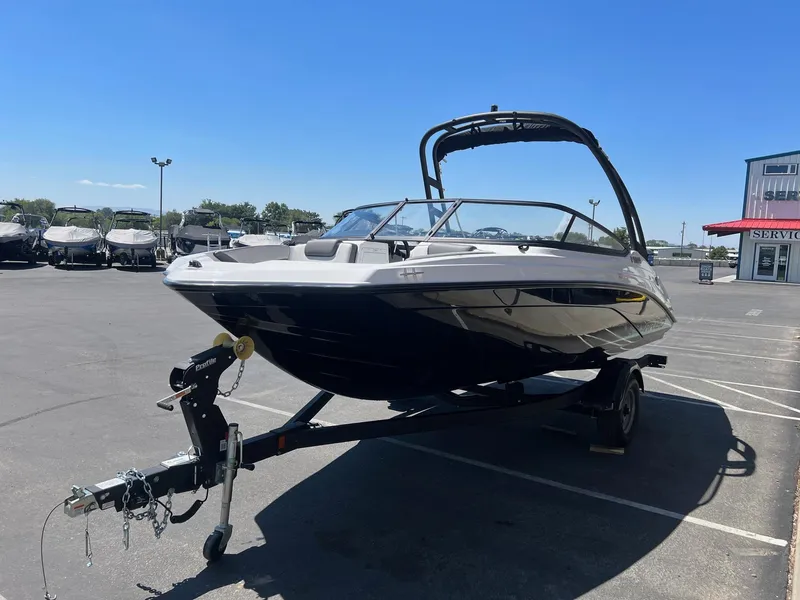 Slide: The Image of 2023 Yamaha AR 190 jet boat on trailer in parking lot, clear sky background. - 6