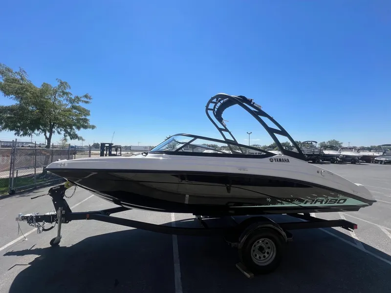 Slide: The Image of 2023 Yamaha AR 190 jet boat on trailer under clear blue sky. - 7