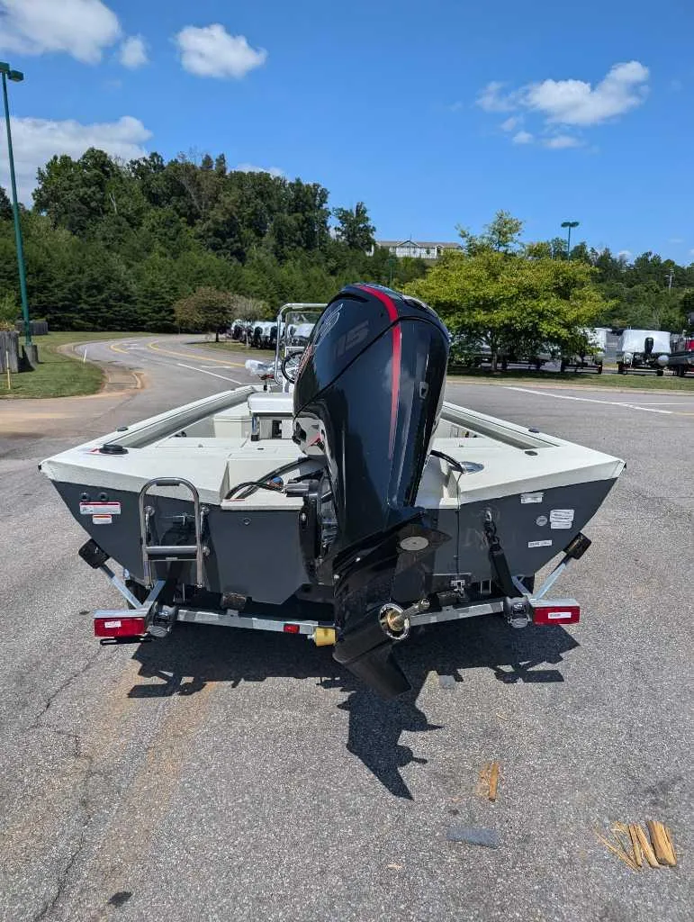 Slide: The Image of 2024 Ranger RB190 boat with outboard motor on a trailer, parked outdoors. - 2