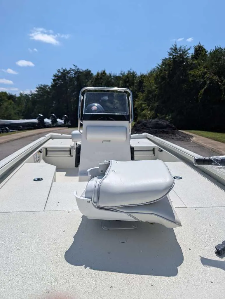 Slide: The Image of 2024 Ranger RB190 boat interior with seating and console, set against a wooded backdrop. - 3